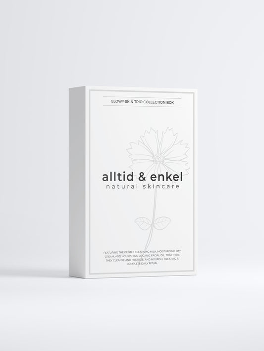 Glowy skin trio collection in a sleek white box from the front on a white background.