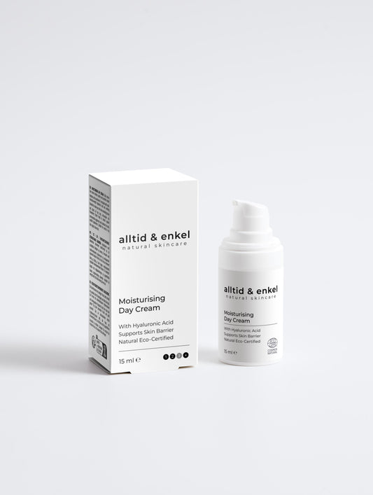 Moisturising day cream in a sleek white bottle with box on a white background, 15 ml.