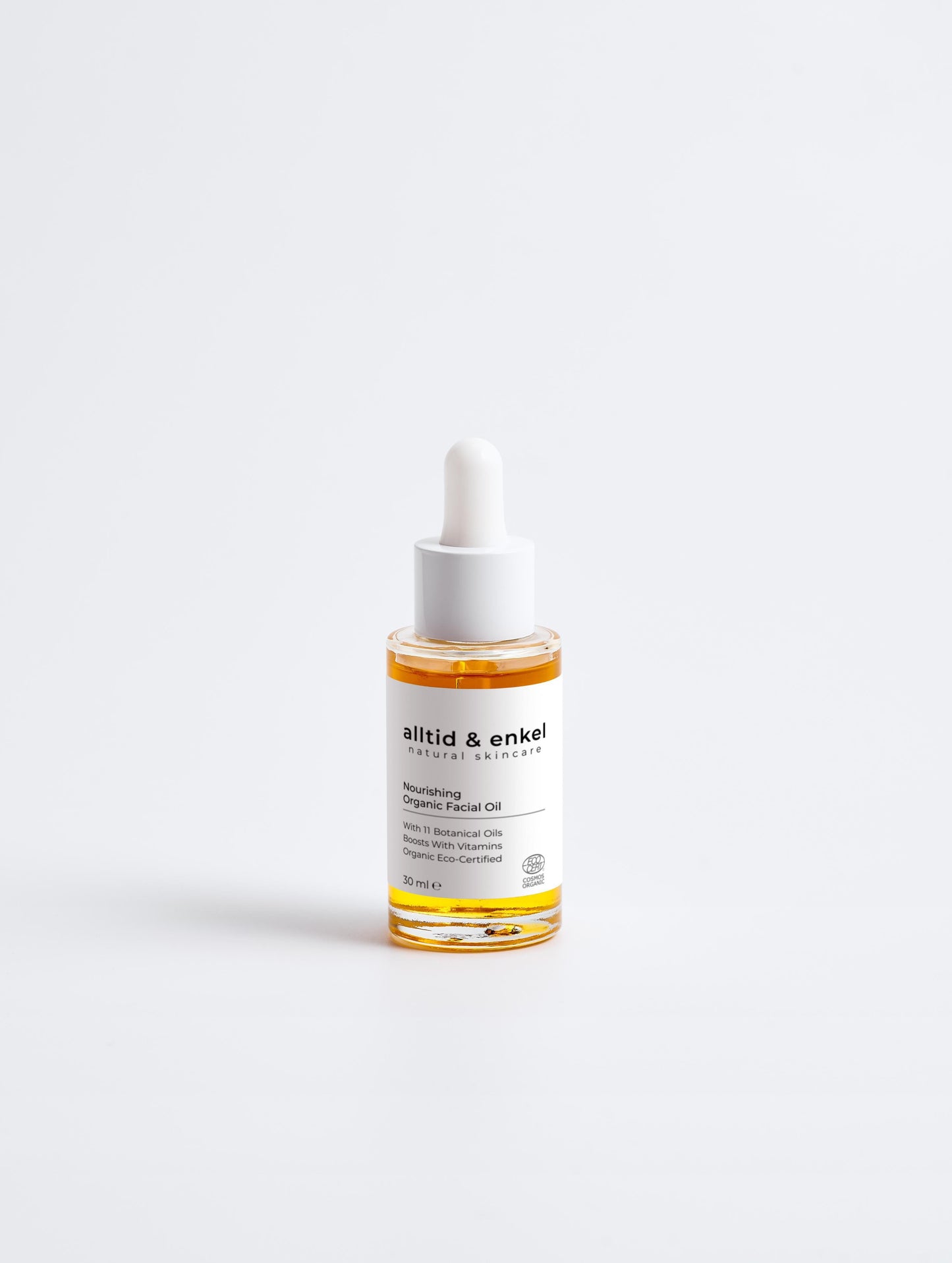Nourishing organic facial oil in a sleek white bottle on a white background, 30 ml.