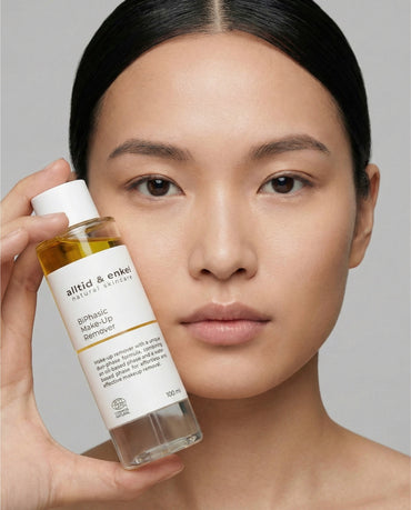 Woman holding BiPhasic Make-up Remover by alltid & enkel
