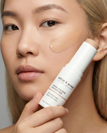 Woman holding Sun Protection SPF50 Stick (with tint) by alltid & enkel