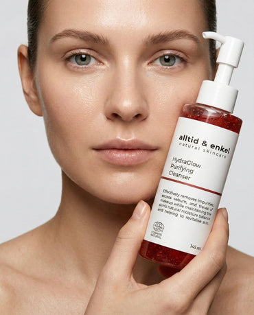 Woman holding HydraGlow Purifying Cleanser by alltid & enkel