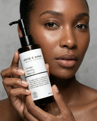 Woman holding Omega 6-9 Glowing Skin Body Oil by alltid & enkel