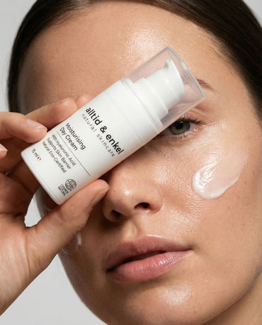 Person applying a skincare product to their face with a bottle labeled 'alltid & enkel'.