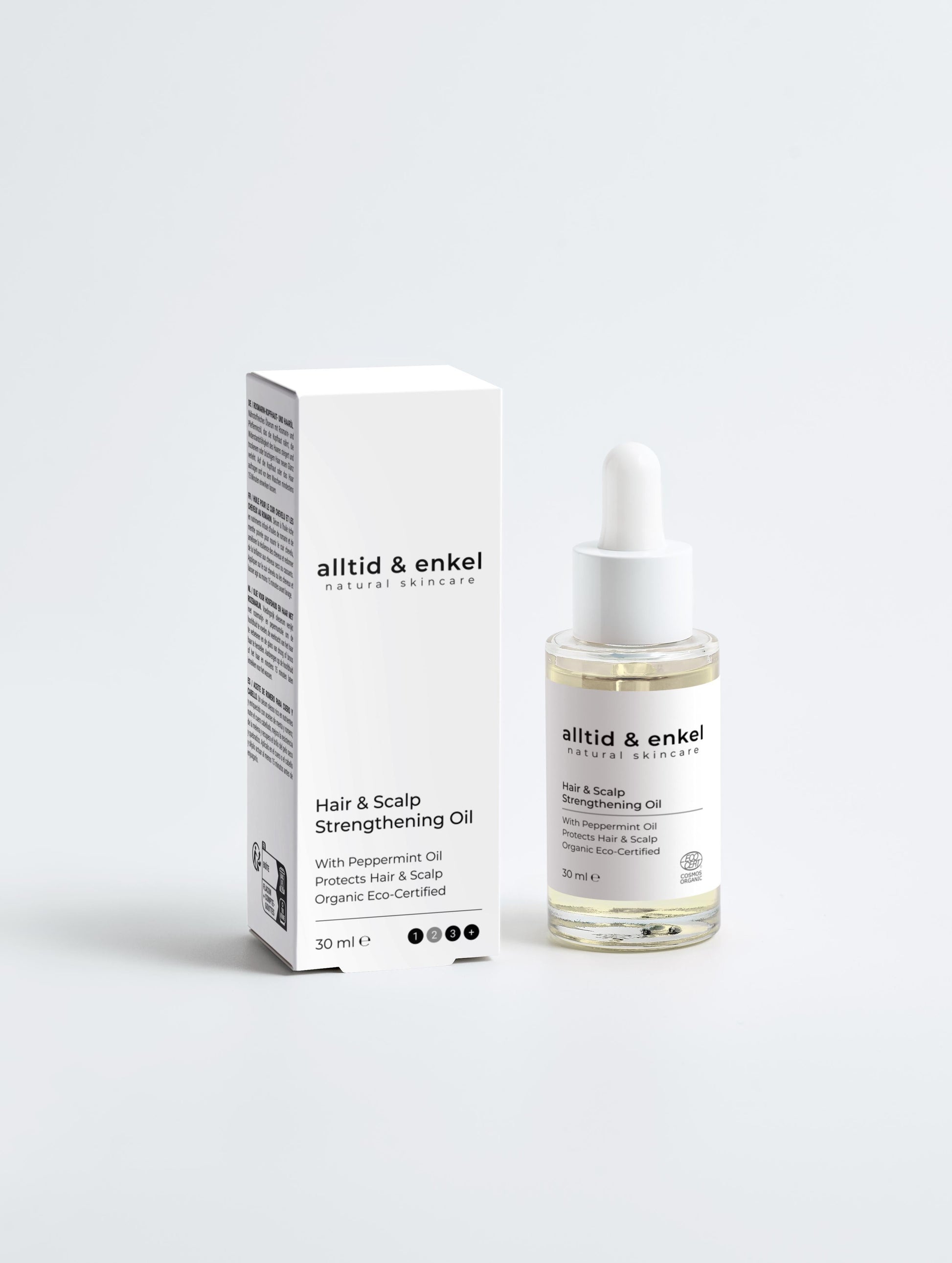 Hair & Scalp Strengthening Oil with pepperming oil next to its packaging box, 30 ml.