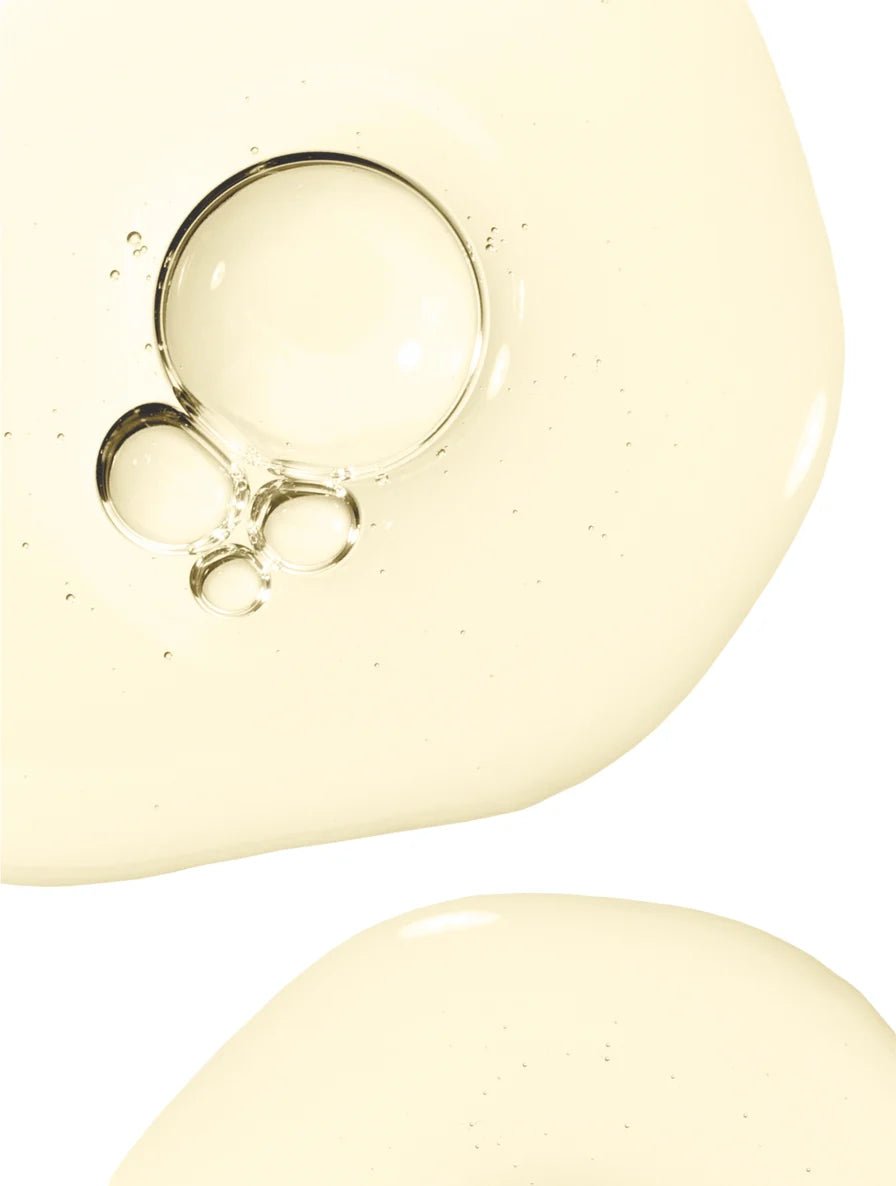 Close-up of hair & scalp strengthening oil texture on a white background.