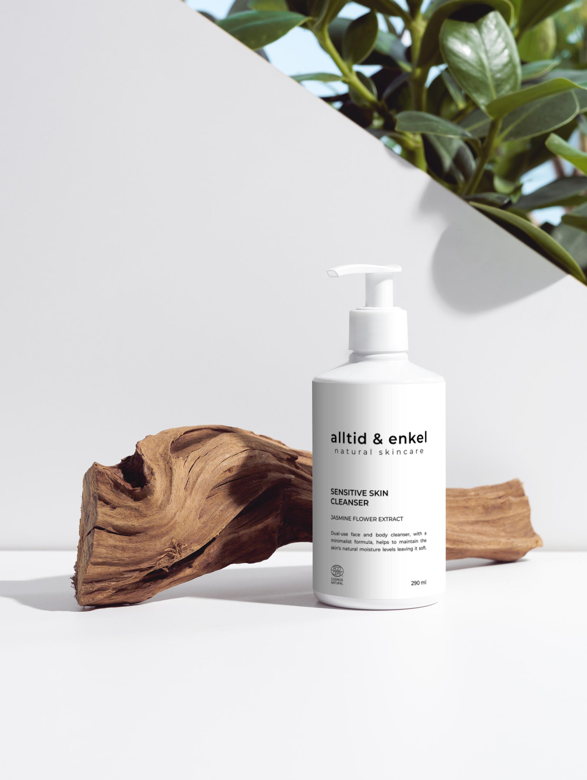 Sensitive skin cleanser in a sleek white bottle on a white surface with a wooden log, 290 ml.