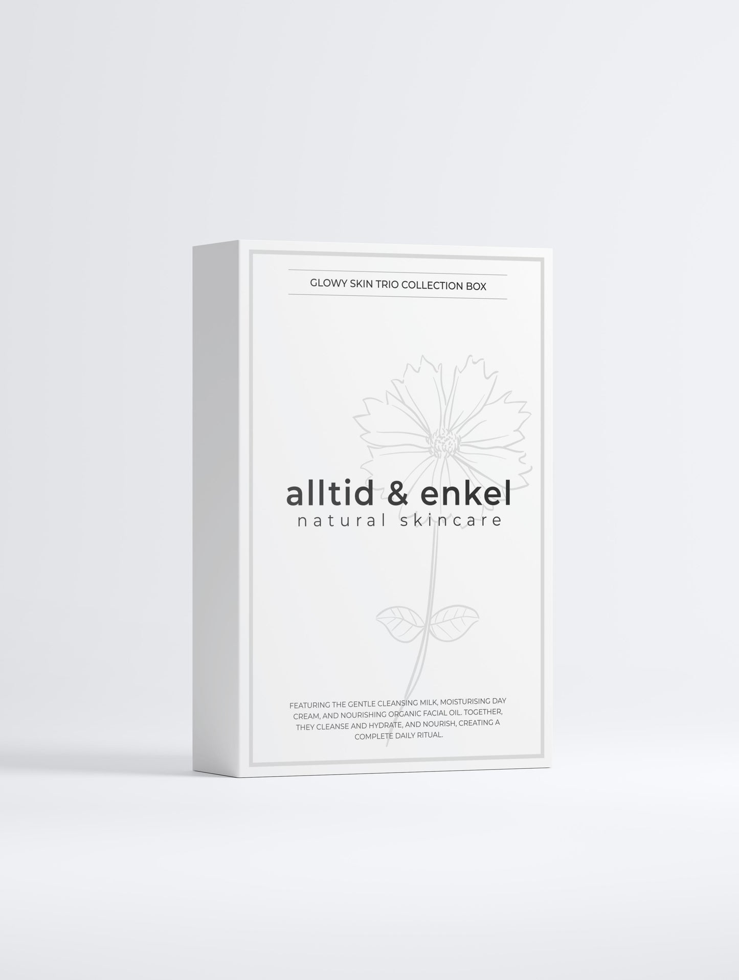 Glowy skin trio collection in a sleek white box from the front on a white background.