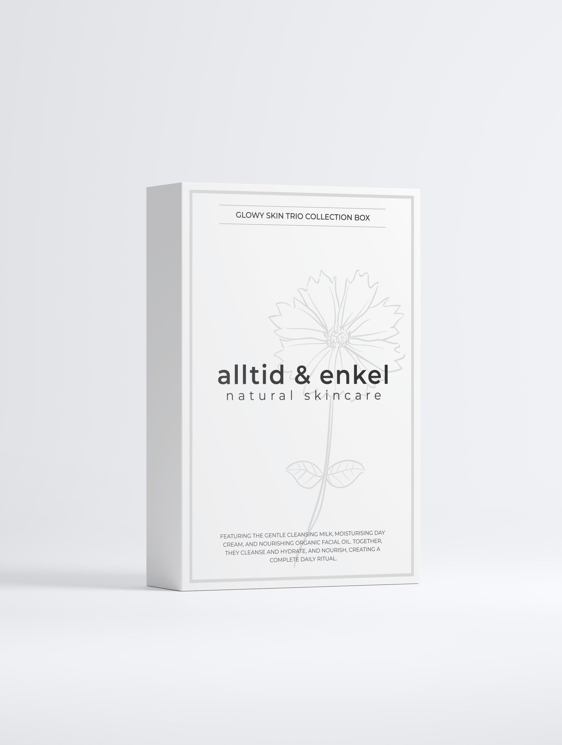 Glowy skin trio collection in a sleek white box from the front on a white background.