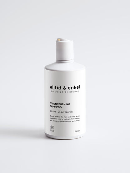 Strengthening shampoo in a sleek white bottle on a white background, 290 ml.
