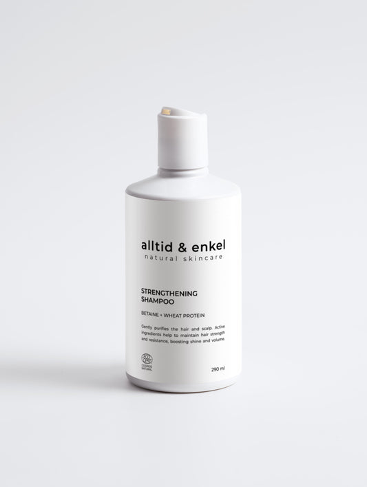 Strengthening shampoo in a sleek white bottle on a white background, 290 ml.