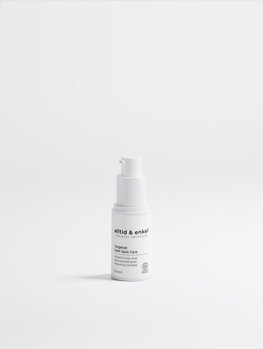Dark spot kojic acid serum in a sleek white bottle on a white background, 15 ml.