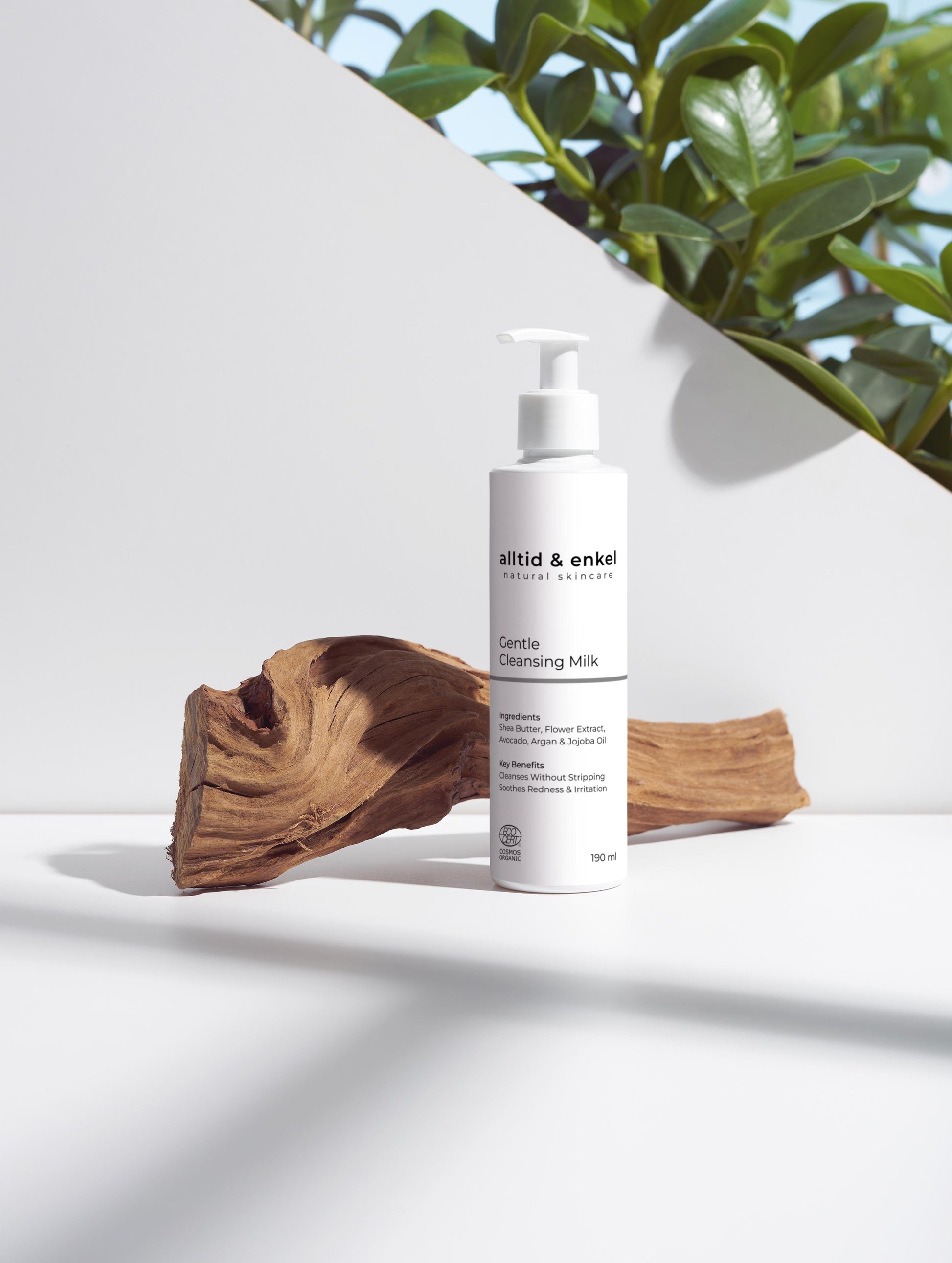 Gentle cleansing milk on a white surface with a wooden log, 190 ml.