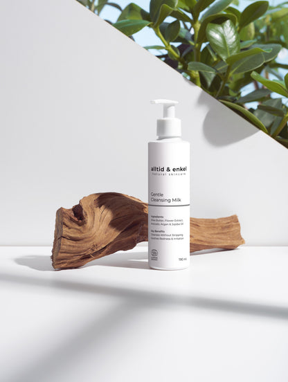 Gentle cleansing milk on a white surface with a wooden log, 190 ml.