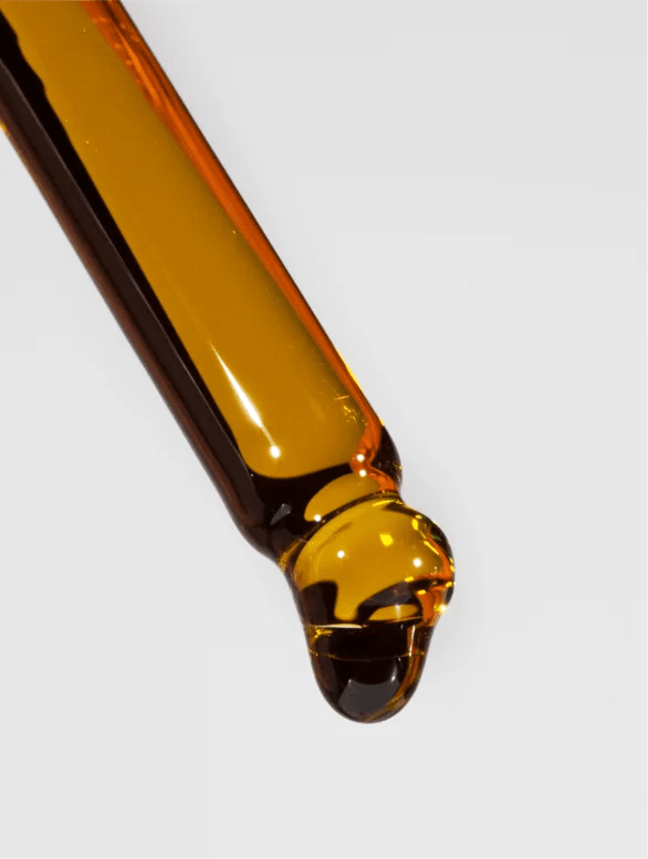 Close-up of nourishing organic facial oil texture on a white background.