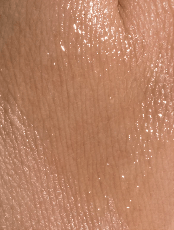 Close-up of nourishing organic facial oil texture on a skin.