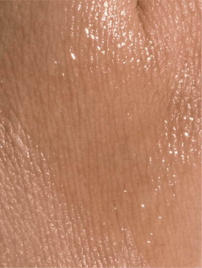 Close-up of nourishing organic facial oil texture on a skin.