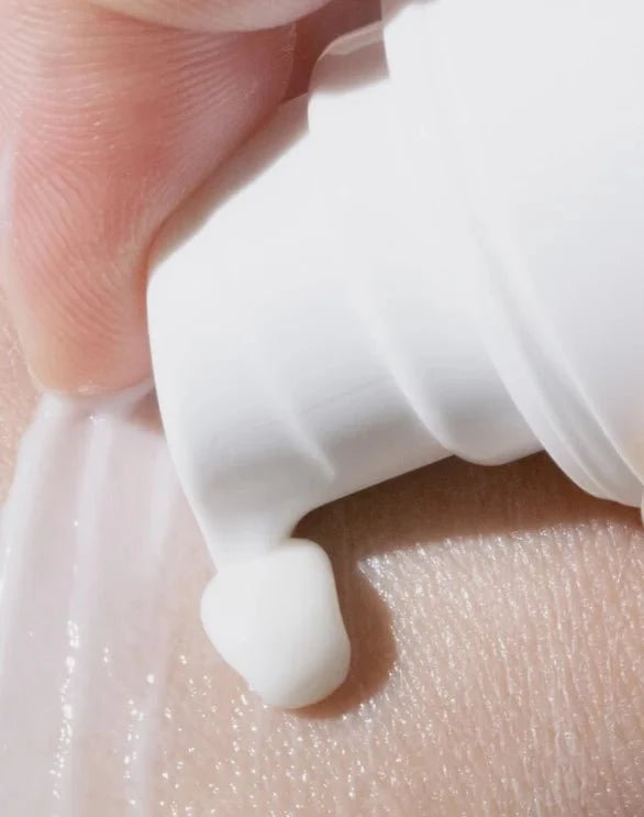 Close-up of calming CBD eye cream texture on a skin background.