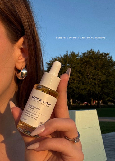 Person holding a bottle of 'alltid & enkel' natural skincare product with a scenic background.