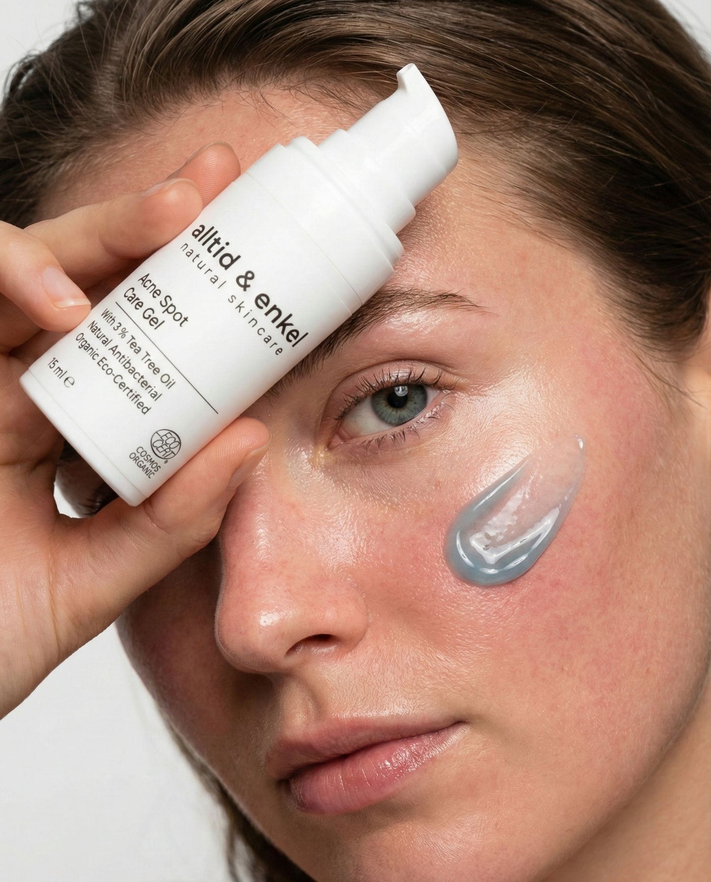 Person applying skincare product to face with 'alltid & enkel' bottle
